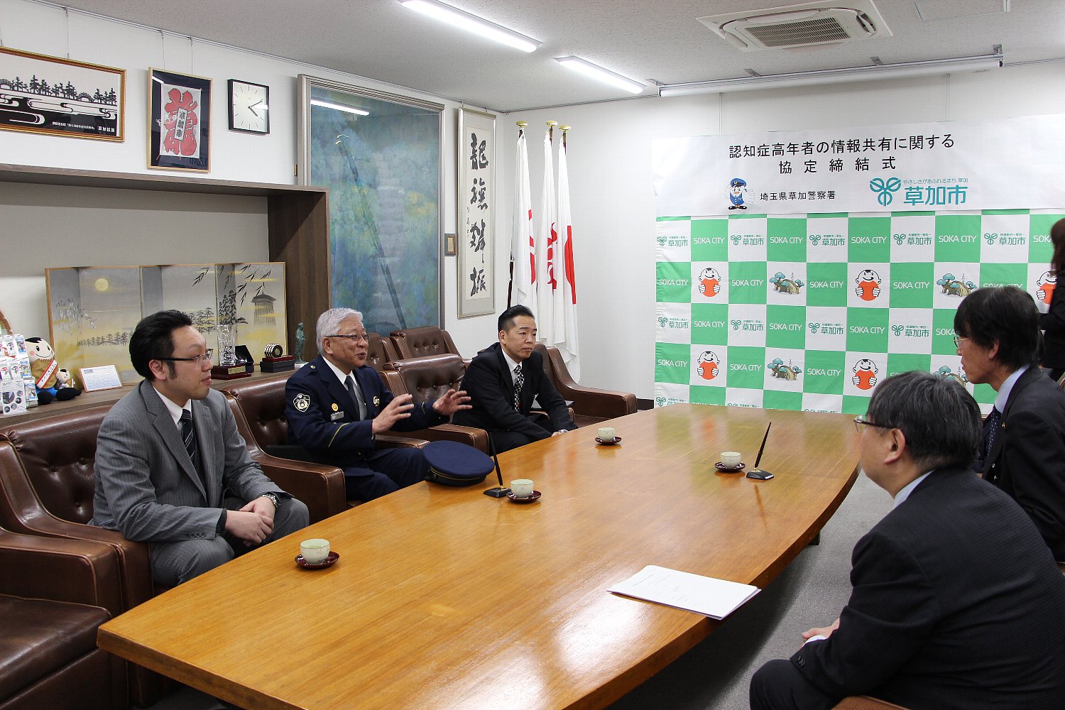 草加警察署内で談話する画像